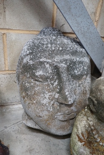 A reconstituted stone Buddha mask garden ornament, height 50cm, together with a seated Buddha garden ornament